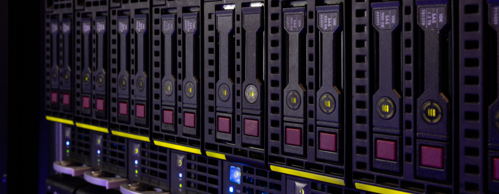 A close-up view of a row of server racks in a data center, showcasing multiple hard drives with indicator lights and labels.